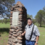 Colonia Juarez colonist Ed Whetten stands next to Temple Hill monument.
